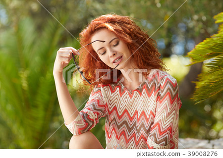 Portrait of an adorable brown-eyed girl with her hand up, combin Portrait of an adorable brown-eyed girl with her hand up, combin 39008276