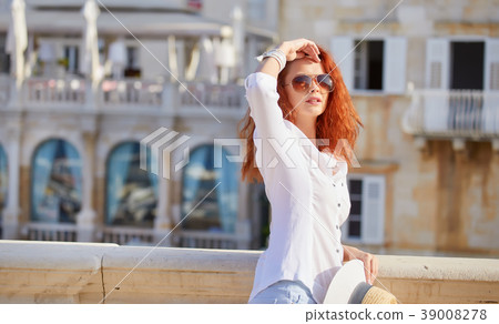 Portrait of an adorable brown-eyed girl with her hand up, combin Portrait of an adorable brown-eyed girl with her hand up, combin 39008278