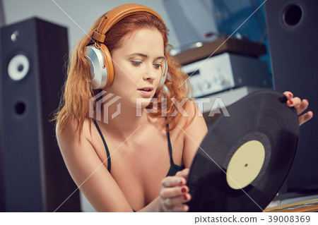 the image of resting sexy woman listening to vinyl 39008369