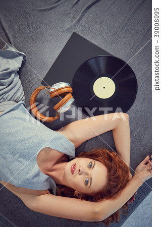 the image of resting sexy woman listening to vinyl 39008995
