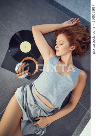 the image of resting sexy woman listening to vinyl 39008997