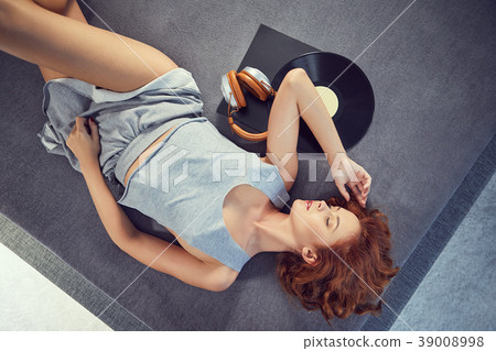 the image of resting sexy woman listening to vinyl 39008998