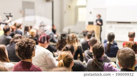 Woman giving presentation in lecture hall at 39009932