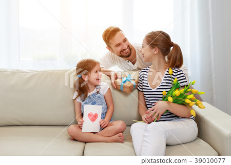 happy mother's day! father and child congratulate mother on holi happy mother's day! father and child congratulate mother on holi 39010077