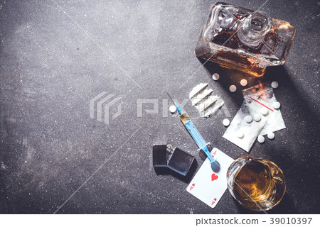 Hard drugs and alcohol on gray stone table Hard drugs and alcohol on gray stone table 39010397