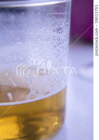 Glass of beer half full 39013701