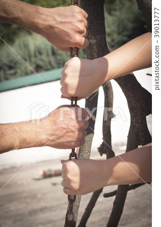 Hands holding and pulling a stick 39013777