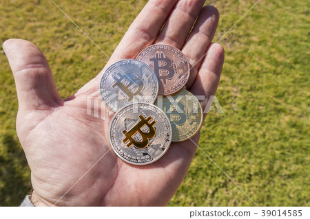 Cryptocurrency coins in a hand, Bitcoin Cryptocurrency coins in a hand, Bitcoin 39014585