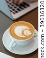 Hot art latte coffee cup on wooden table 39016320