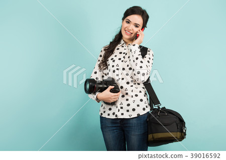 Young woman with camera and its case 39016592