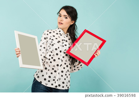 Young woman with two blank frames 39016598