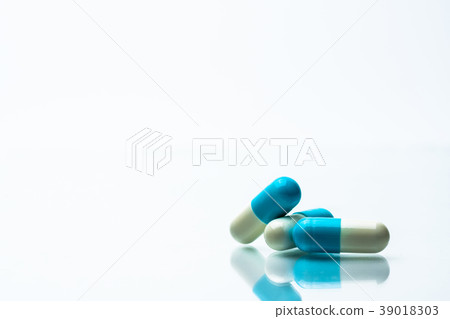 Three blue and white capsules pills Three blue and white capsules pills 39018303