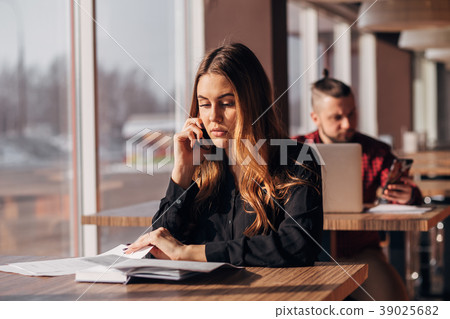 businesswoman sitting at the table and talking on 39025682