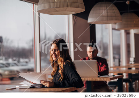 businesswoman with documents in her hands smiling businesswoman with documents in her hands smiling 39025690