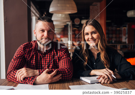 two happy freelancer smiling at camera in cafe two happy freelancer smiling at camera in cafe 39025837