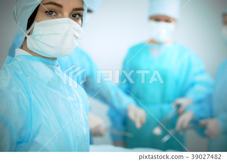 Medical team in masks performing operation. Focus 39027482