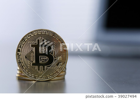 Golden Bitcoin facing the camera in sharp focus 39027494