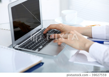Close up of business woman hands typing on laptop Close up of business woman hands typing on laptop 39027559