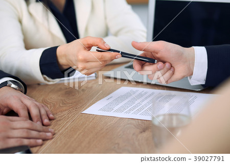 Business woman giving pen to businessman ready to 39027791