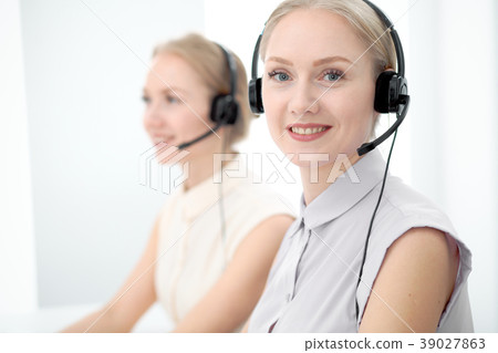 Image of bright call center. Focus on young Image of bright call center. Focus on young 39027863