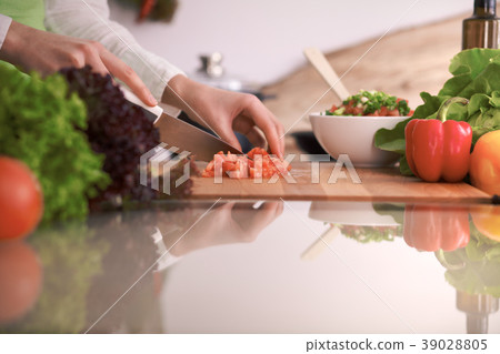 Close Up of human hands cooking vegetable salad in 39028805