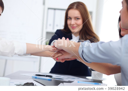 Close Up of unknown business people joining hands Close Up of unknown business people joining hands 39028942