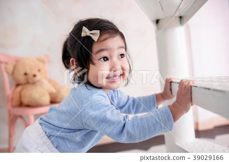 2 Years Old Child Smiling while Playing Hide& Seek 2 Years Old Child Smiling while Playing Hide& Seek 39029166