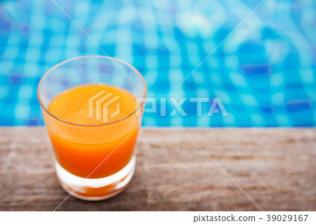 Relaxation with Orange Juice at the Poolside 39029167