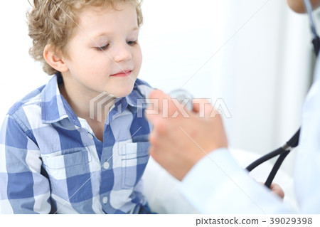 Doctor and child patient. Physician examines Doctor and child patient. Physician examines 39029398
