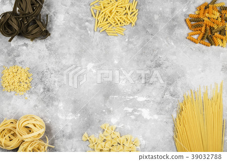 Various raw pasta on gray background. Top view Various raw pasta on gray background. Top view 39032788