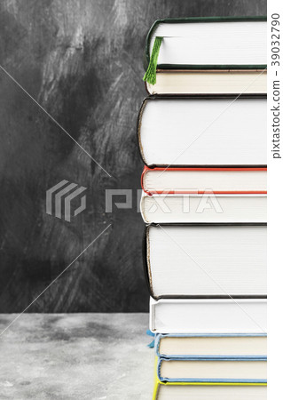 Pile of various books on dark background Pile of various books on dark background 39032790