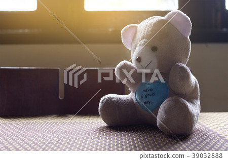 Alone teddy bear sitting on table, Sad concept. Alone teddy bear sitting on table, Sad concept. 39032888