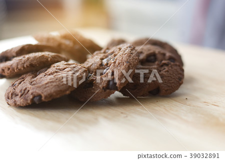 Chocolate cookies on wooden table. Chocolate cookies on wooden table. 39032891
