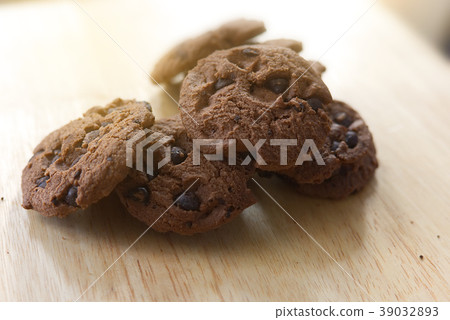 Chocolate cookies on wooden table. Chocolate cookies on wooden table. 39032893