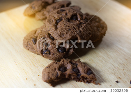 Chocolate cookies on wooden table. Chocolate cookies on wooden table. 39032896