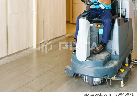 man operates rider floor Scrubber Machine man operates rider floor Scrubber Machine 39040071