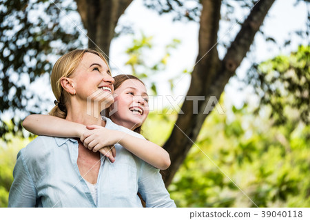 Mother and daughter having fun together in a park. Mother and daughter having fun together in a park. 39040118