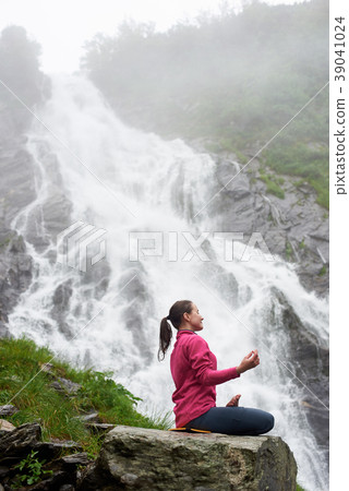 Pretty young girl meditating in nature. Pretty young girl meditating in nature. 39041024