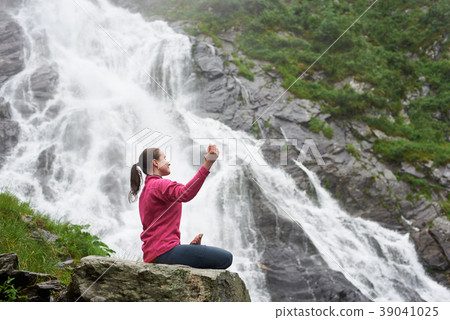 Girl sits in profile at lotus pose enjoying mountain air Girl sits in profile at lotus pose enjoying mountain air 39041025