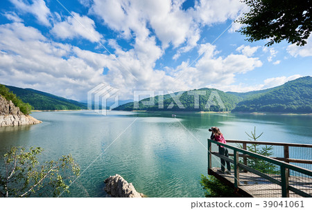 Photographer female on the lake Vidraru Carpathians Romania Photographer female on the lake Vidraru Carpathians Romania 39041061