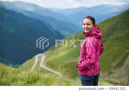 Close-up young woman on blurred background of green mountains, Romania Close-up young woman on blurred background of green mountains, Romania 39041181