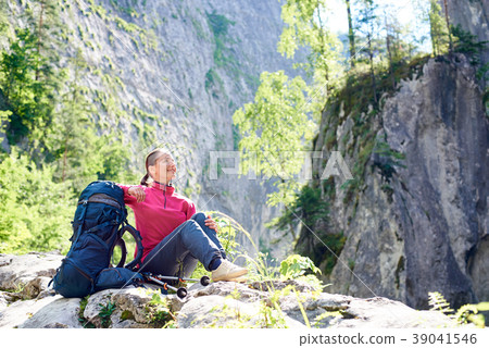 tourist resting on rock admiring tourist resting on rock admiring 39041546