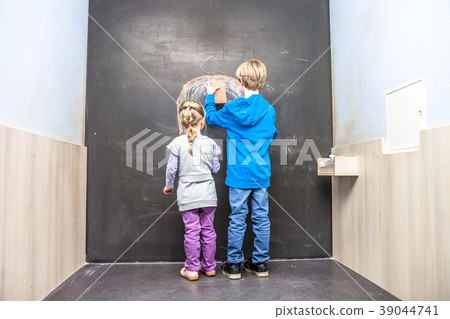 Boy and girl using chalkboard 39044741