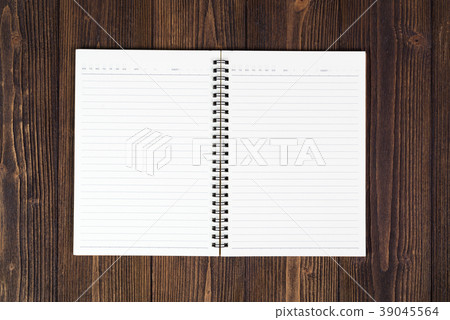 Notebook or empty white paper on wood table Notebook or empty white paper on wood table 39045564
