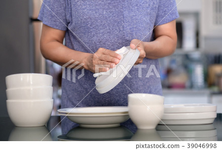 Woman Cleaning product concept wiping dishware  39046998