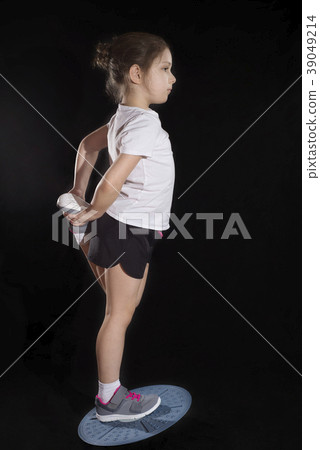Little caucasian girl in on one leg position on 39049214