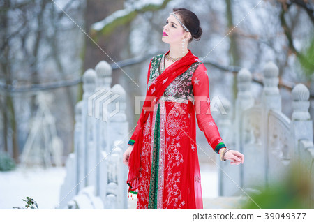 Woman in oriental dress in a winter park Woman in oriental dress in a winter park 39049377