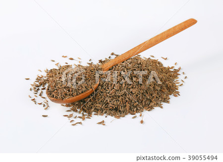 pile and spoon of caraway seeds pile and spoon of caraway seeds 39055494