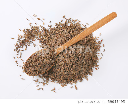 pile and spoon of caraway seeds pile and spoon of caraway seeds 39055495