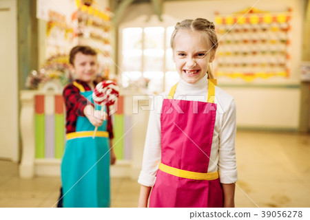 Boy gives handmade lollipop to stubborn girl Boy gives handmade lollipop to stubborn girl 39056278